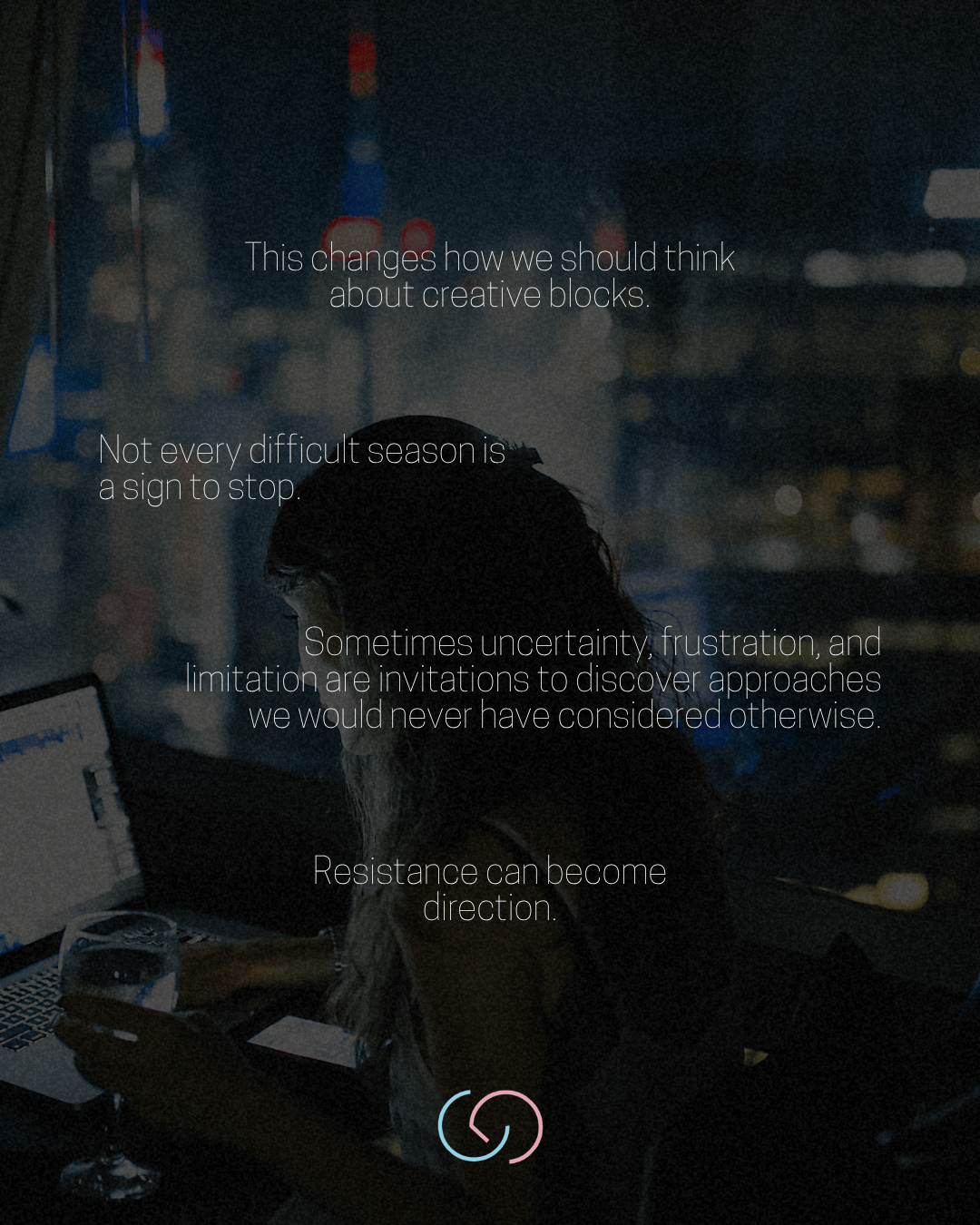 A person seated in a dimly lit room, working on a laptop, with a glass of drink in hand. The background features city lights at night. Inspirational text overlays encourage rethinking creative blocks and embracing uncertainty.