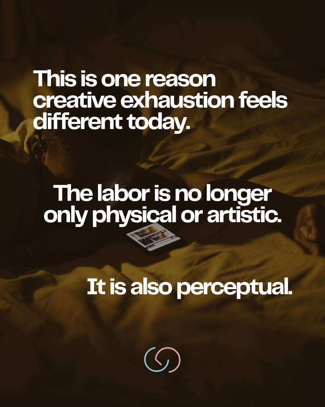 A person resting on a bed while looking at a phone, with text discussing the modern experience of creative exhaustion.