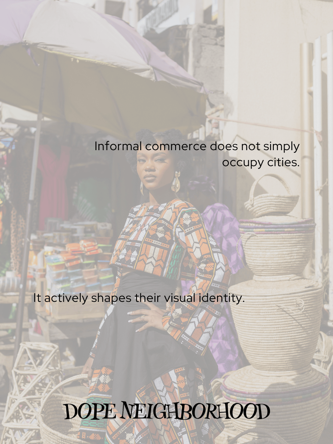 A woman in a colorful, patterned outfit poses confidently in a bustling market setting, with various goods and handmade products visible in the background.