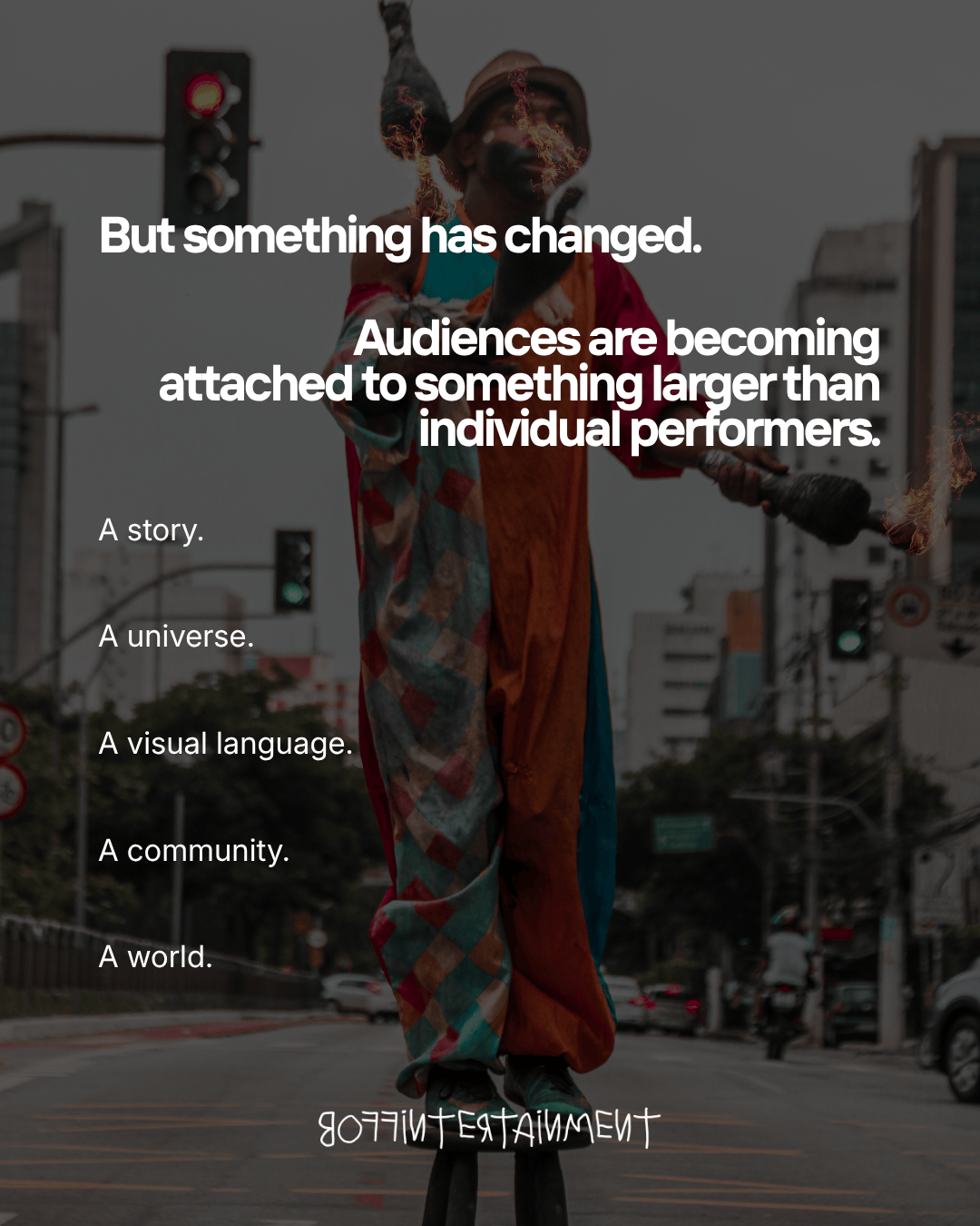 A performer juggling fire while standing on stilts in an urban setting, with text overlay discussing audience connection to larger narratives and communities.