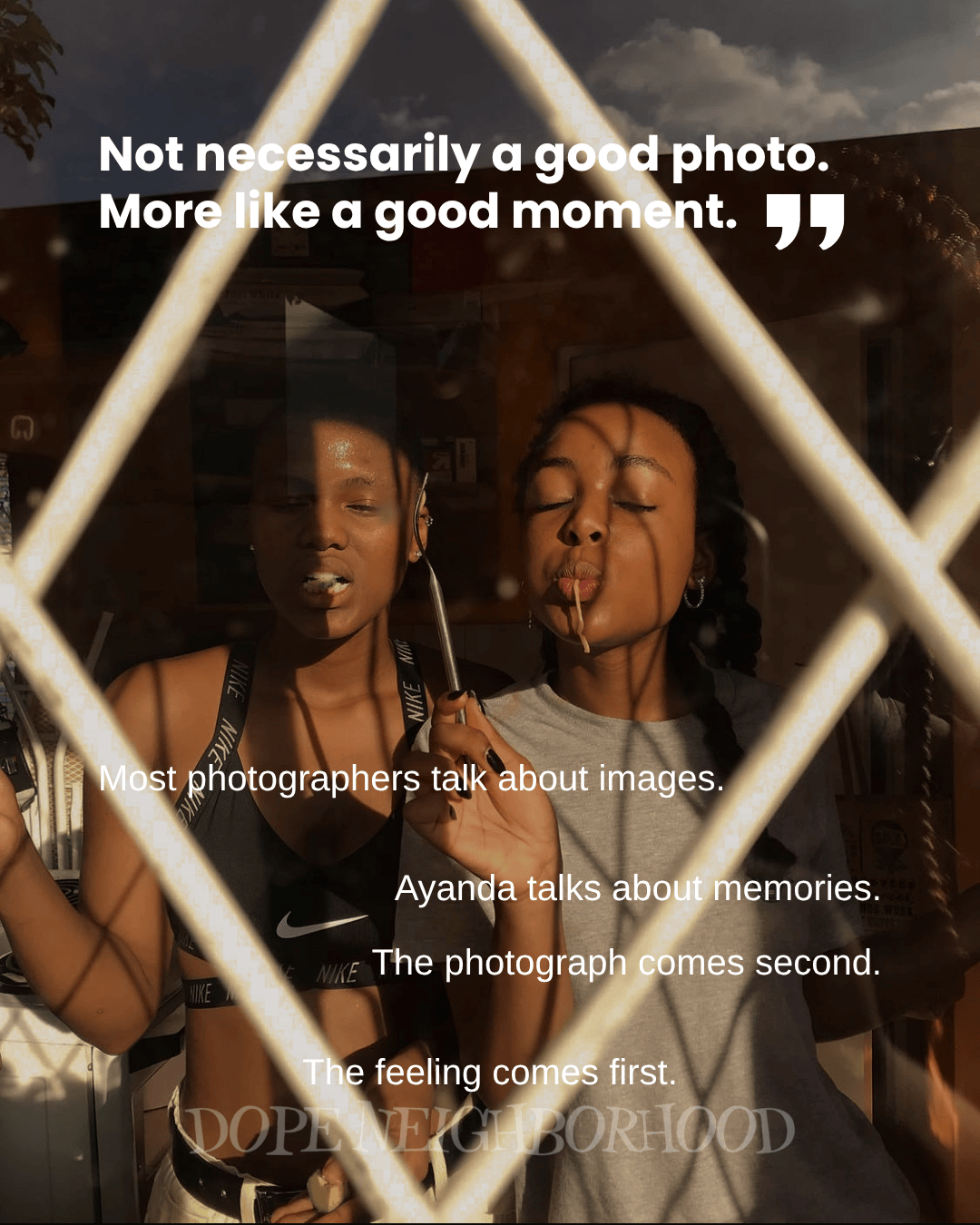 Two young women enjoying a moment, framed by a window with a grid pattern; one holds a drink and the other has a straw in her mouth, both with smiles and playful expressions.