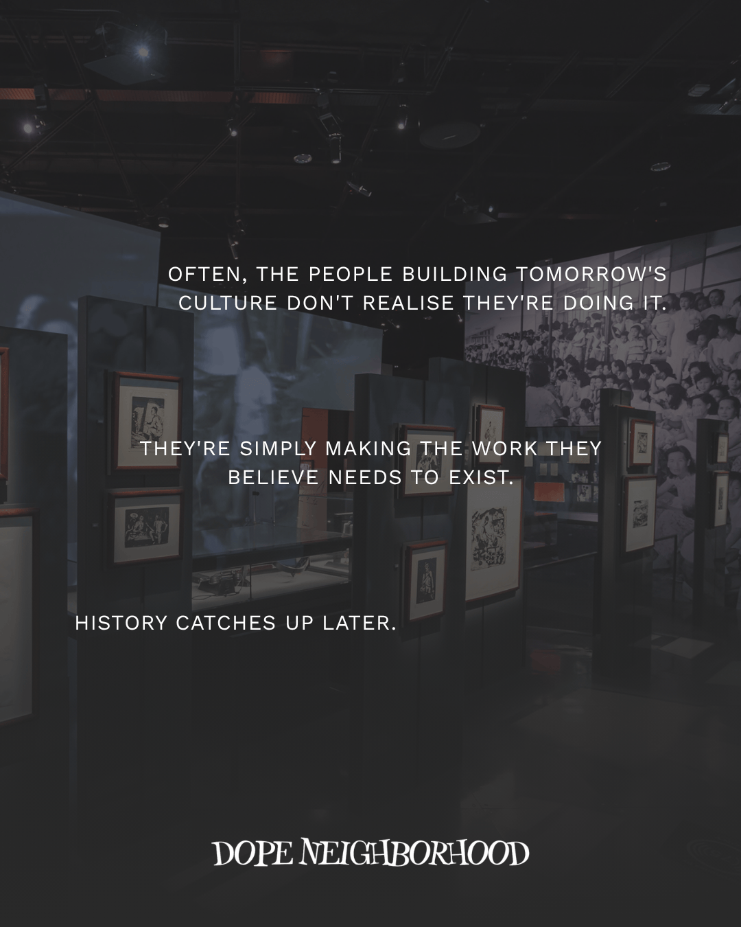 An art exhibit with framed pictures displayed on dark walls, accompanied by a quote about cultural creation and historical significance.