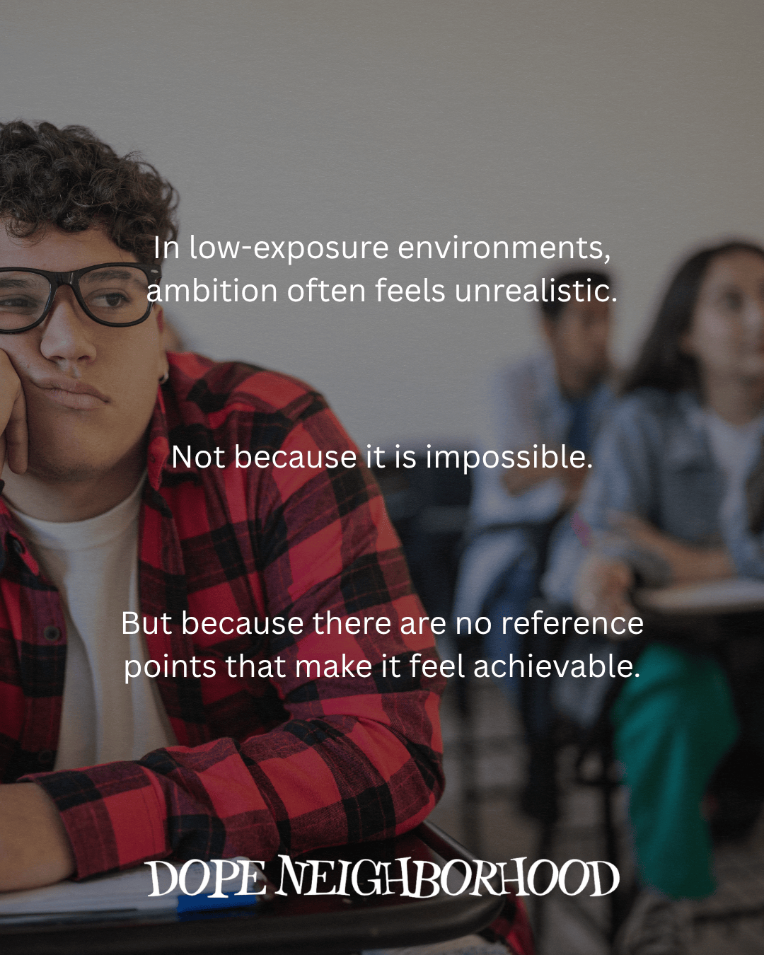 A thoughtful student in a classroom setting, resting their chin on their hand, wearing a red checkered shirt. Text overlay discusses the challenges of ambition in low-exposure environments.