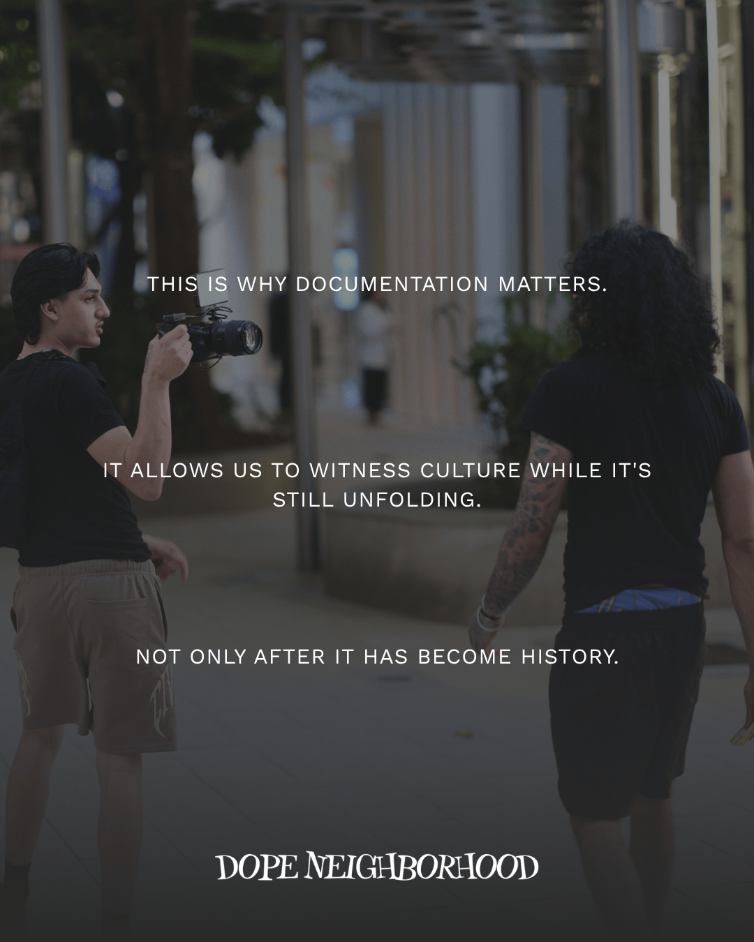 Two individuals walking in an urban environment, one holding a camera. Text overlays discuss the importance of documenting culture as it unfolds.