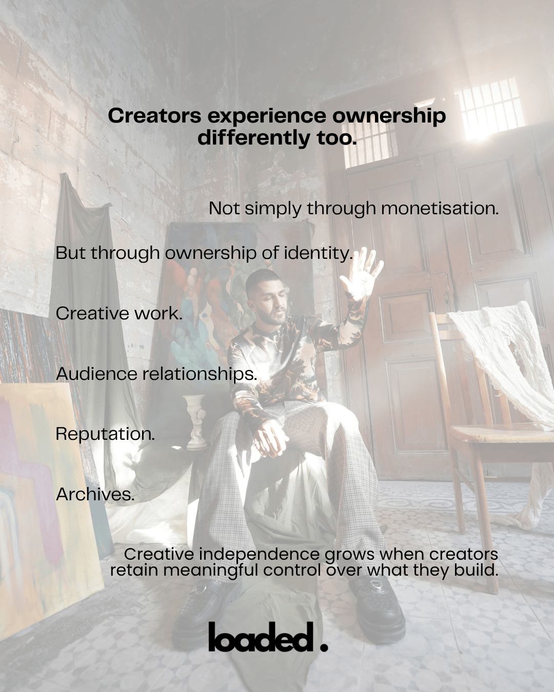 A person seated in a creative space, expressing concepts of ownership and independence through identity and creative work.