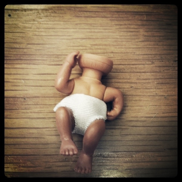 It looks like a partially headless baby taking a phone call.