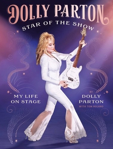 Book cover featuring Dolly Parton in a white outfit holding a guitar, promoting her autobiography 'Dolly Parton: Star of the Show - My Life on Stage'.