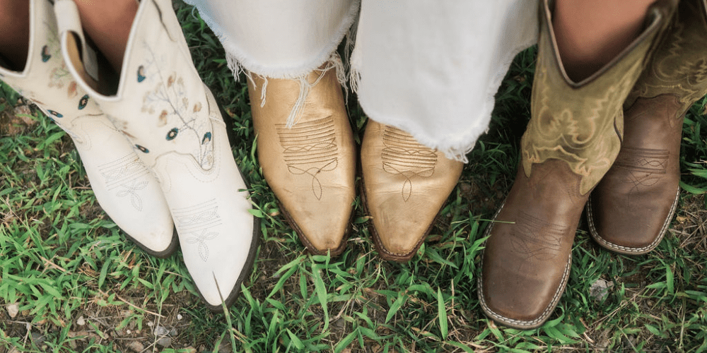 Mother and children's cowboy boots all in a row.