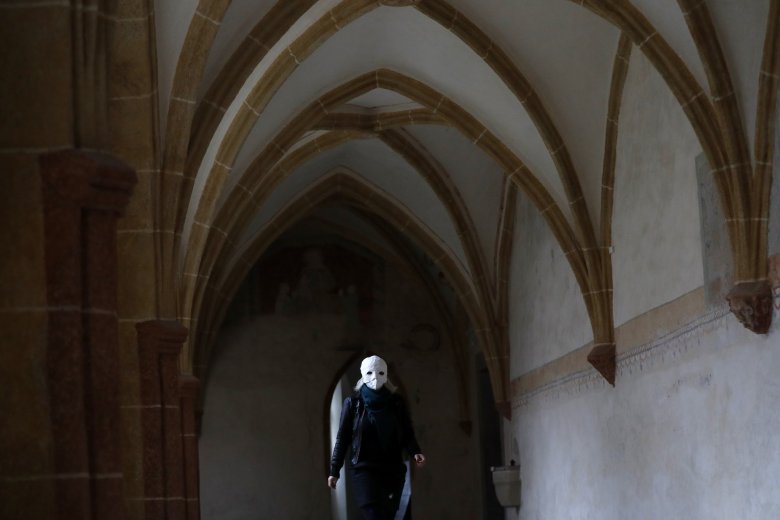 A participant wearing a mask prepares to take part in an Easter procession marching through the streets in Ceske Budejovice, Czech Republic, Friday, April 2, 2021. (AP Photo/Petr David Josek)