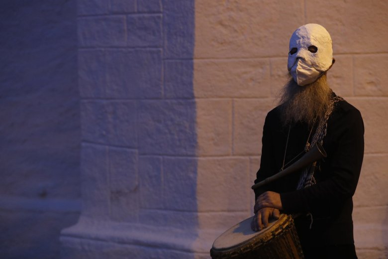 A participant wearing a mask takes part in an Easter procession marching through the streets of Ceske Budejovice, Czech Republic, Thursday, April 1, 2021. (AP Photo/Petr David Josek)