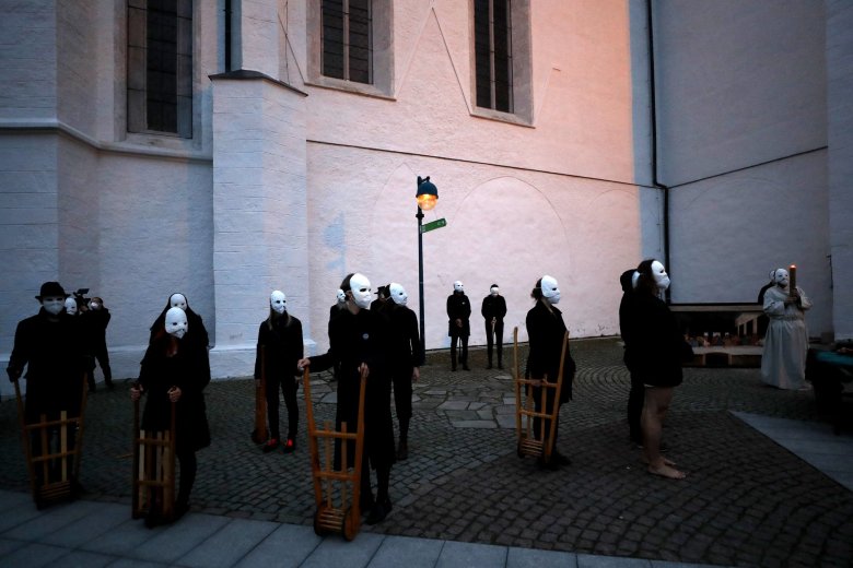 Participants wearing masks take part in an Easter procession marching through the streets of Ceske Budejovice, Czech Republic, Thursday, April 1, 2021. (AP Photo/Petr David Josek)