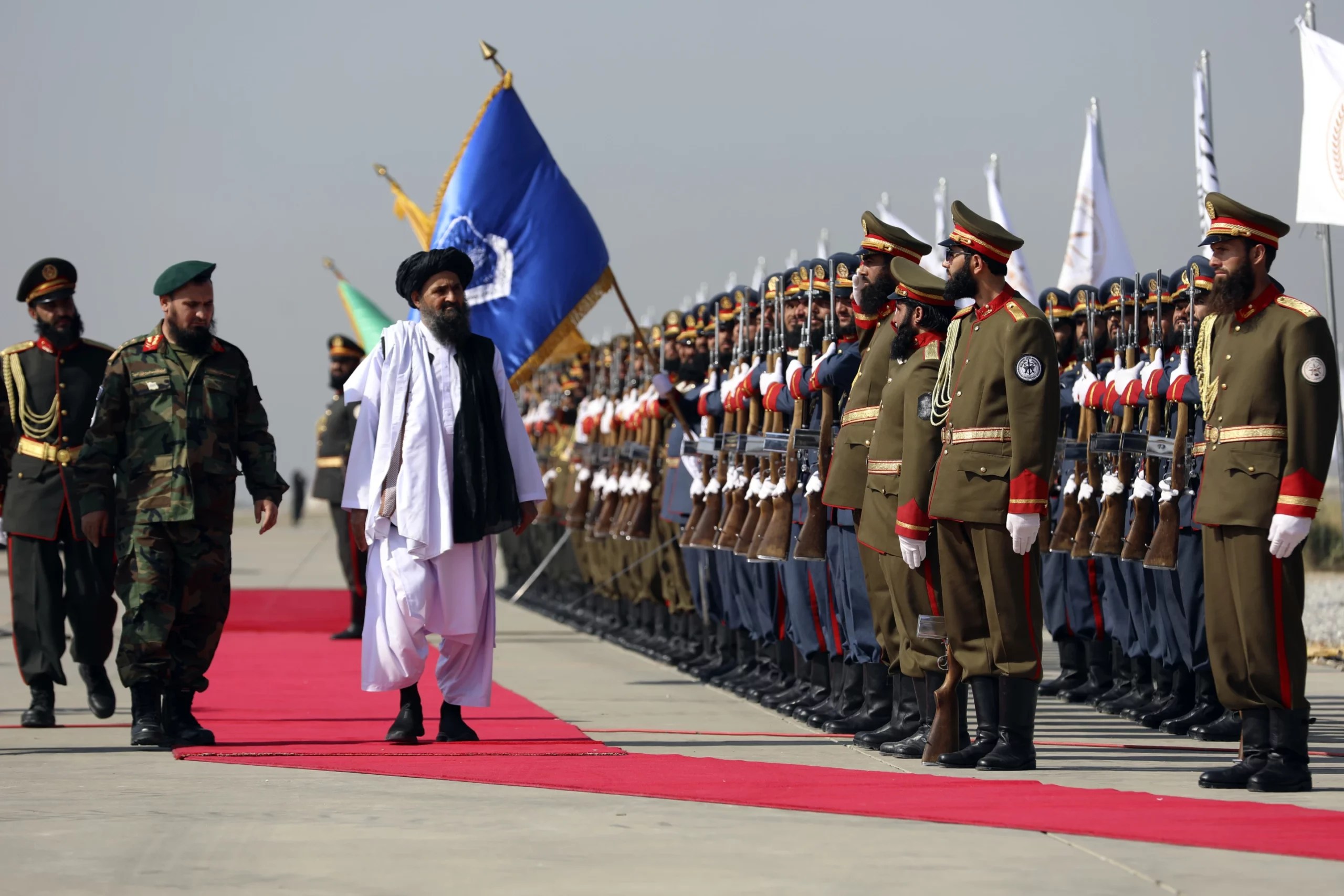 Mullah Abdul Ghani Baradar, the Taliban-appointed deputy prime minister for economic affairs, inspects the honor guards at Bagram Air Base in in the Parwan Province of Afghanistan on Aug. 14, 2024. (Credit: Siddigullah Alizai/AP.)