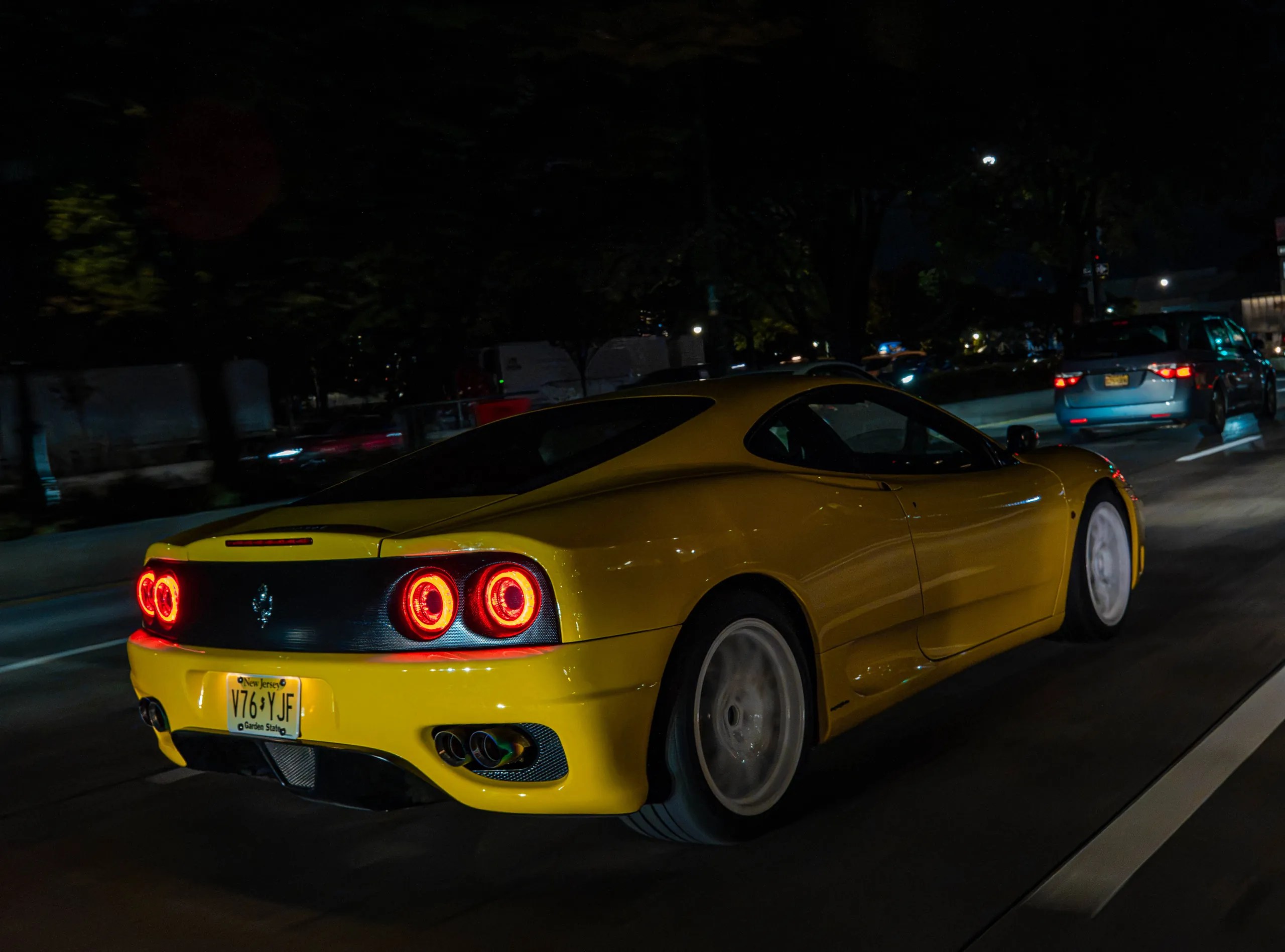 Yellow Ferrari 360 Modena rolling shot on the streets of New York City at night