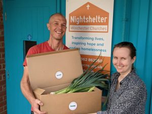 two people with box of vegtables