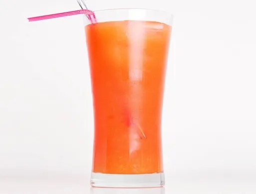 Sex on the Beach sans alcool servi en verre long drink avec tranche d'orange