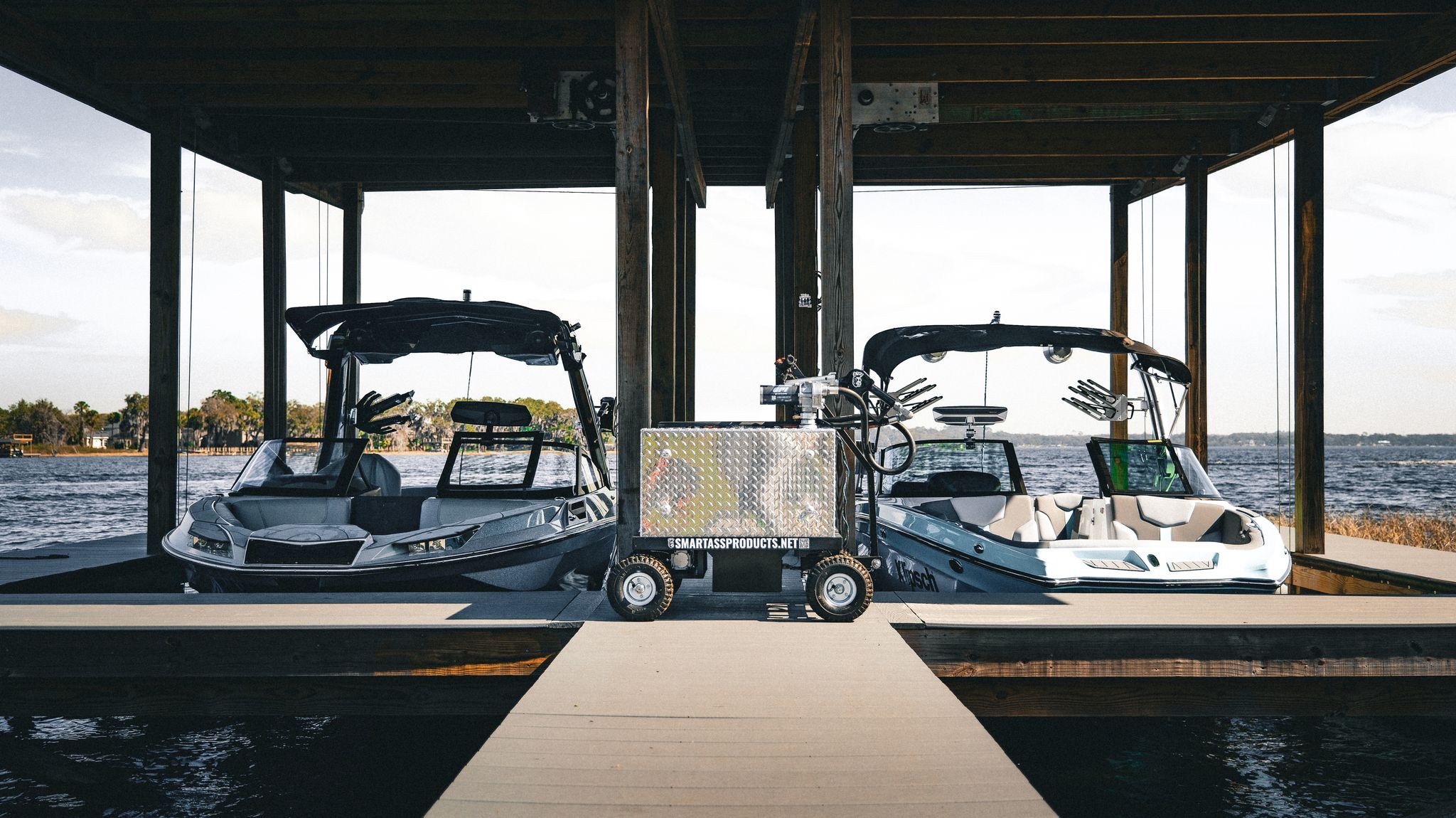 Smart Ass Fuel Mule gas caddy on a dock between two wake surfing boats