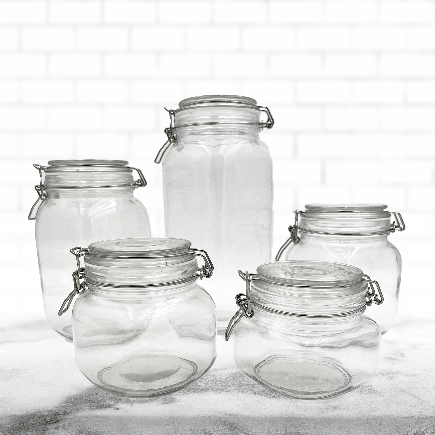 Set of five blank glass canisters of five different sizes