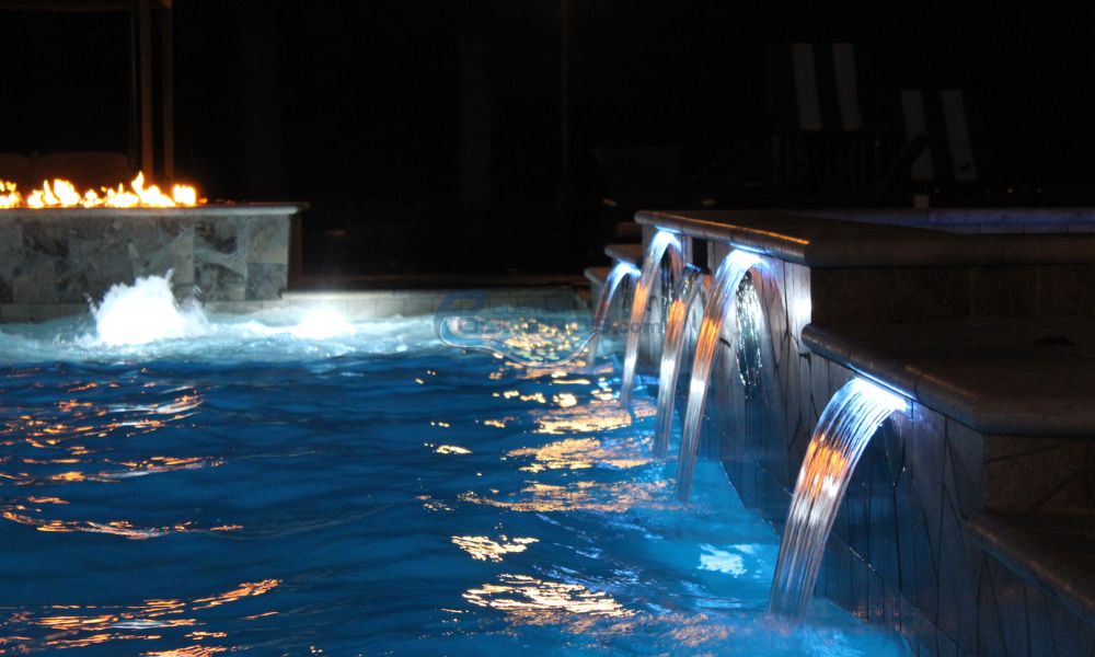 waterfalls in pool with fire pit