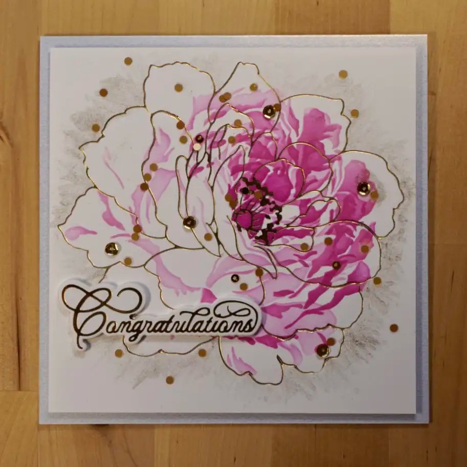 Gorgeous handmade luxury wedding card colored with layered stencils and adorned with gold accents.