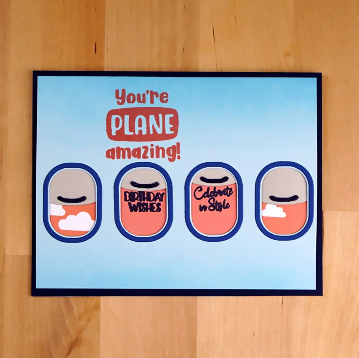 Cute card that is Plane Amazing! This card uses die-cuts and stamping to create the image of looking through airplane windows. And, it even has window shades that move up and down.
