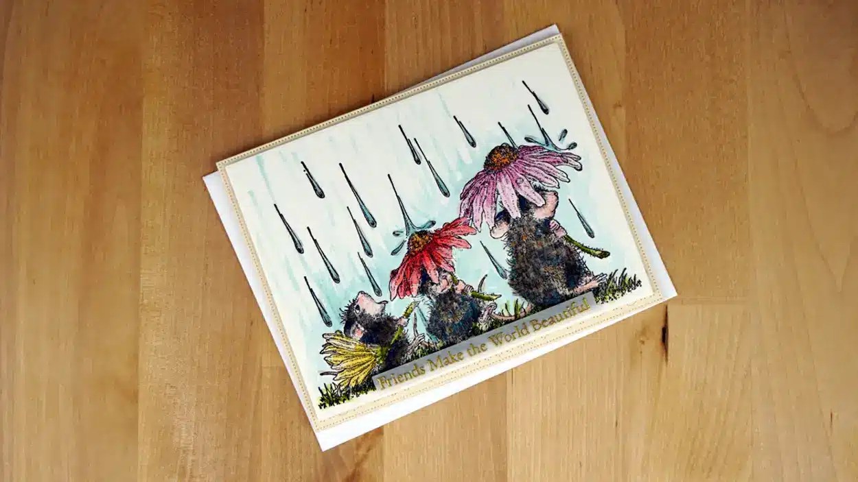 A greeting card from the Spring Collection featuring three House Mice under flowers as rain falls, with text that reads "Friends Make the World Beautiful.
