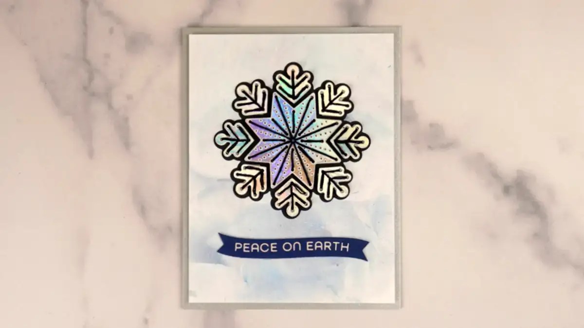 A card with a stitched snowflake on it.