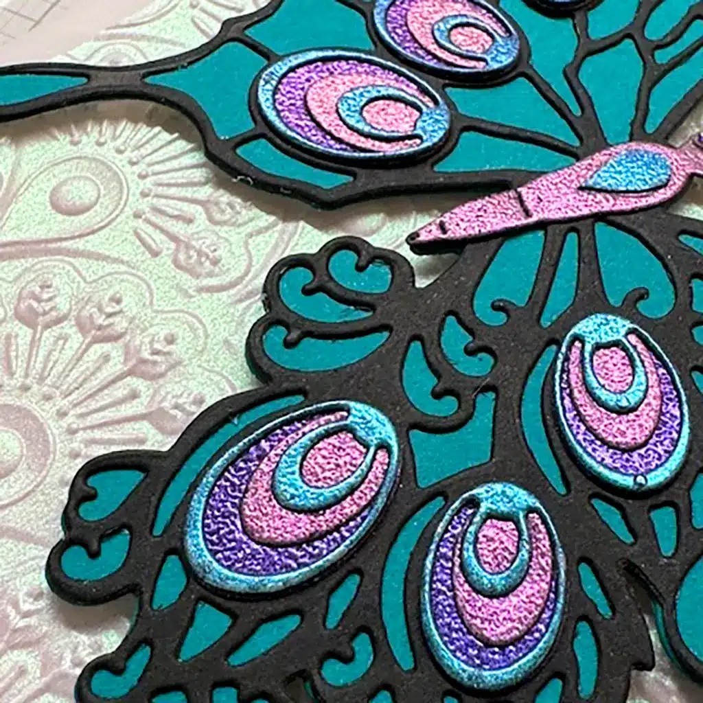 Close-up of the shimmer created with iridescent embossing powders.