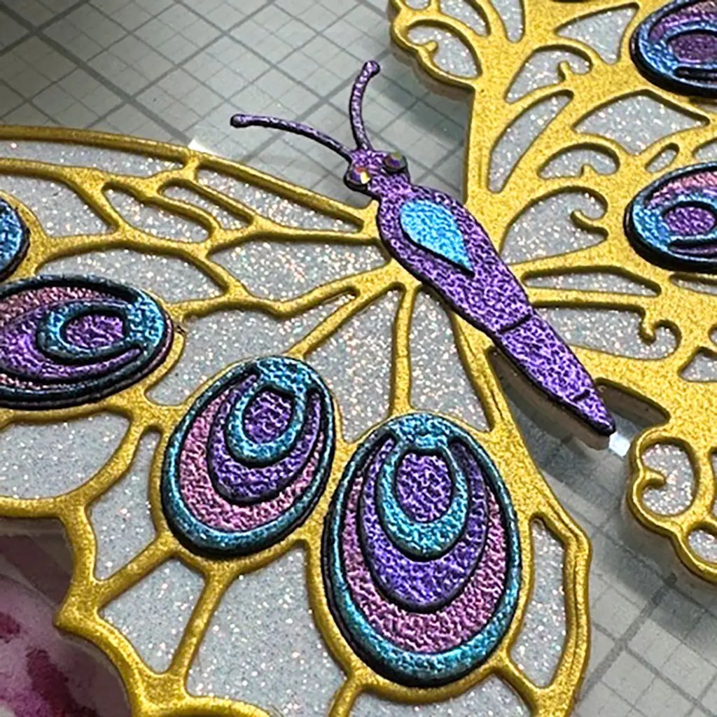 detail on the Glitter and shimmer card made using Spellbinders Peacock butterfly.
