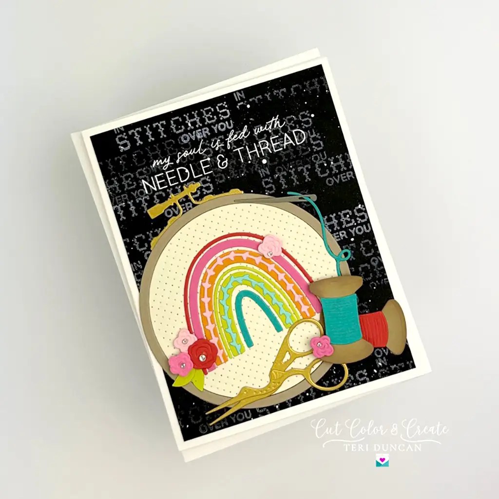 Rainbow Needle & Thread card featuring a cross stitched rainbow, scissors, and threat created with Spellbinders Nichol's Needlework Collection