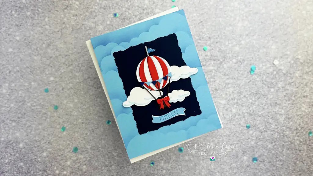 Greeting card featuring a hot air balloon illustration, perfect for Day 1 of your festive journey. The red, white, and blue balloon floats amidst clouds with "HELLO" on a banner. Set against a light blue background sprinkled with confetti, it's reminiscent of jubilant Advent calendars.
