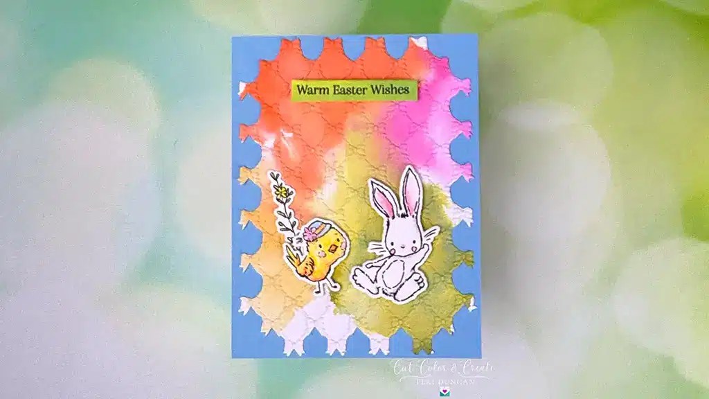 A colorful Easter card from the Spring Release collection, featuring a chick with a flower and a sitting rabbit. The card boasts a gradient background, adorned with the words "Warm Easter Wishes." Perfect for spreading holiday cheer.