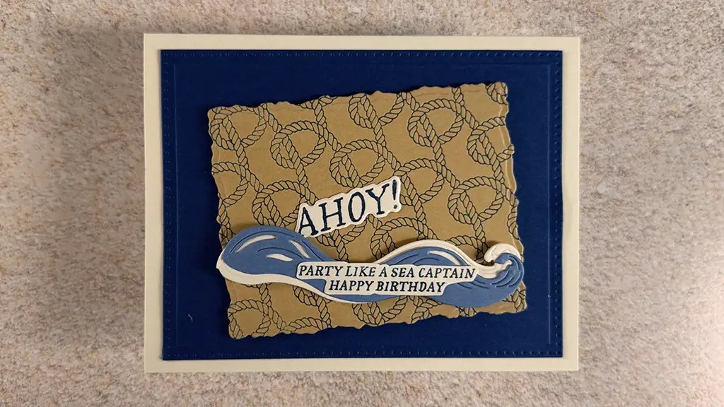 A handmade Nautical Card featuring a rope background, the word "AHOY!" and a wave design that says "PARTY LIKE A SEA CAPTAIN HAPPY BIRTHDAY." Make using Spellbinders June '25 Club Kits.
