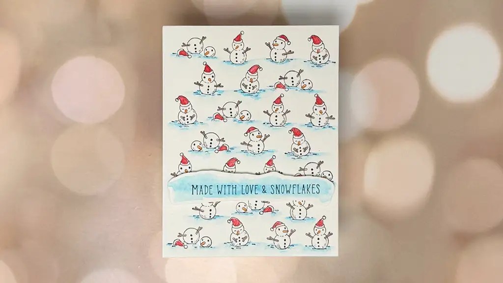 Charming Holiday Greeting Card featuring hand-drawn snowmen in Santa hats; text reads "MADE WITH LOVE & SNOWFLAKES" on a blue banner—perfect inspiration if you want to make holiday cards this season.