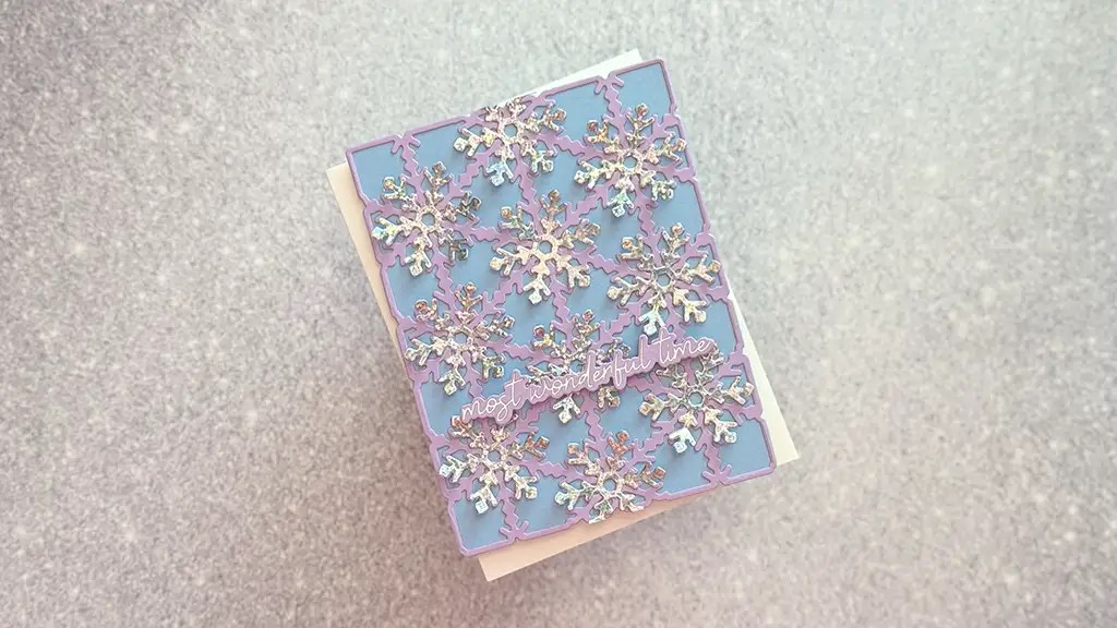 A handmade card with a blue front decorated with iridescent snowflakes and the words miles apart but just as close in cursive scriptperfect for those seeking beautifully crafted handmade snowflake kisses cards