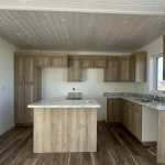 A kitchen with light brown NEXGEN cabinet doors. Every supplier has different standards for NEXGEN doors.