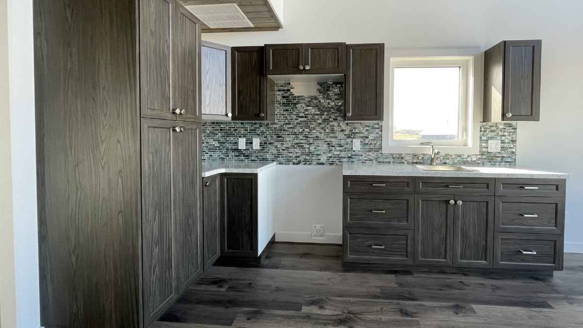 A kitchen with dark brown NEXGEN cabinet doors. NEXGEN cabinet doors are cost-effective and durable.