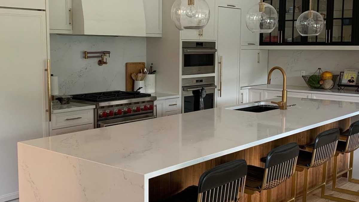 A kitchen with a combination of white and black painted cabinet doors, and wood cabinet doors. Wood cabinet doors work well under a variety of finishes.