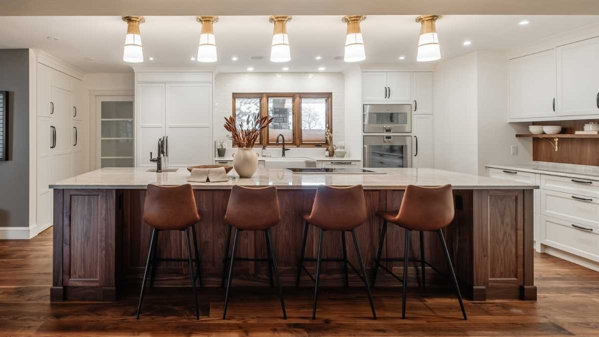 A kitchen with a combination of white painted and Walnut wood cabinet doors. Wood cabinet doors are durable and flexible.
