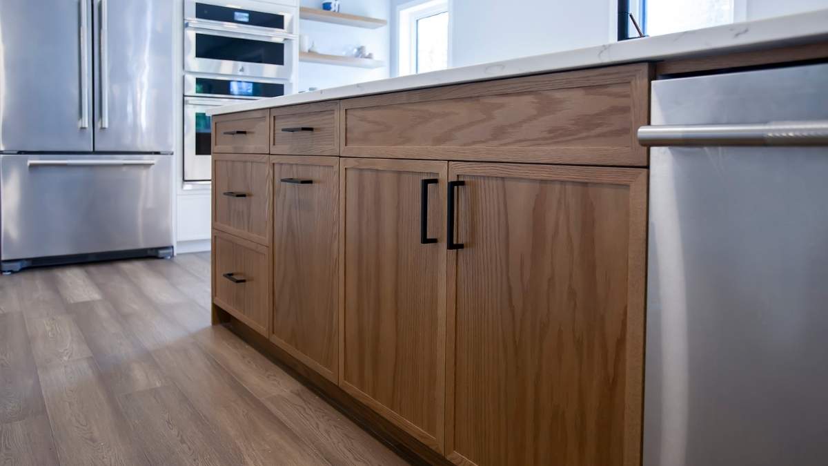 A kitchen with Red Oak slim shaker wood cabinet doors on the island. Wood cabinet doors are highly customizable.