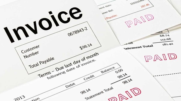 A stack of invoices, all marked as paid. Cutting Edge sends an invoice for accessorial charges within two weeks of you receiving your order.