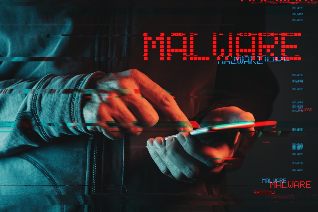 Malware concept with person using smartphone – Cyber Tips Guide
