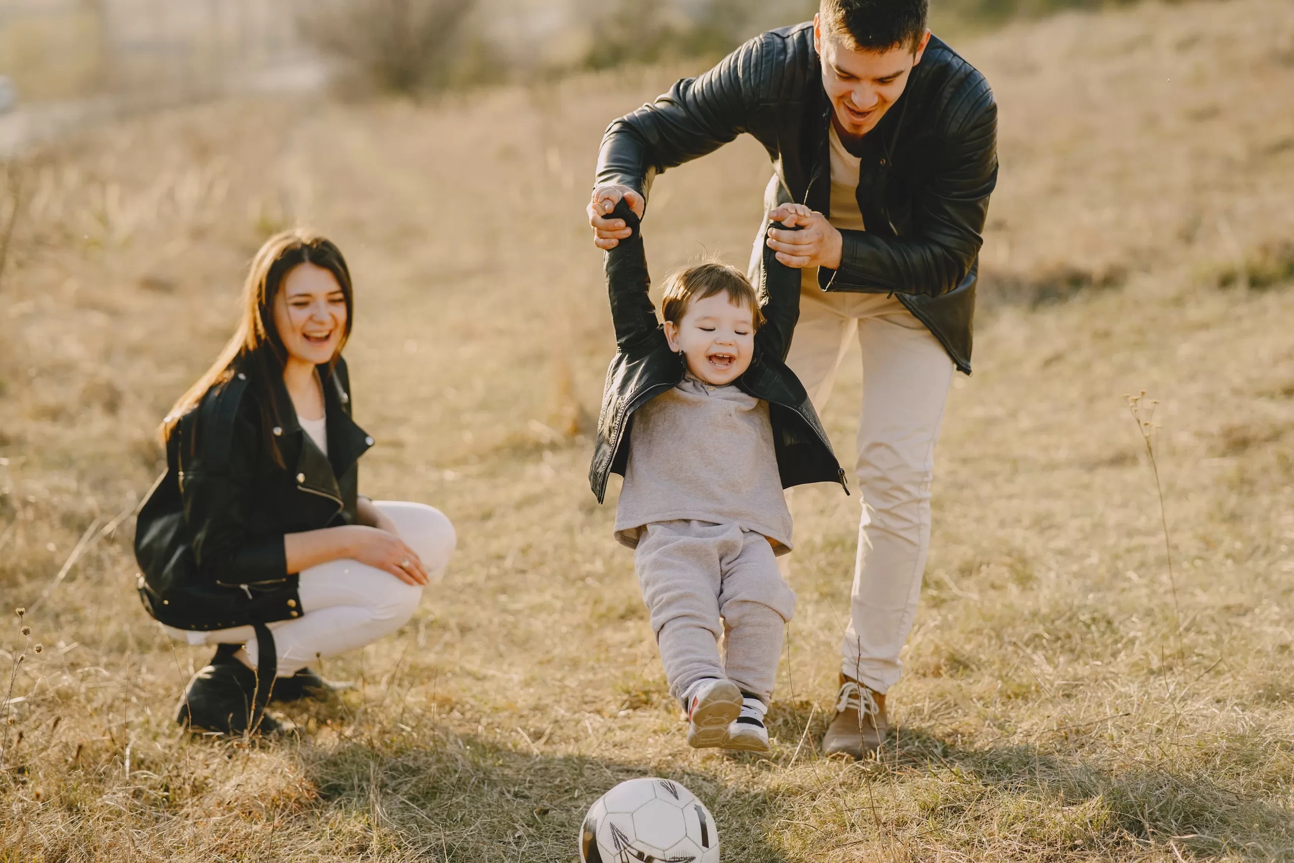 Spending time with family. Dad skipping along with his daughter.