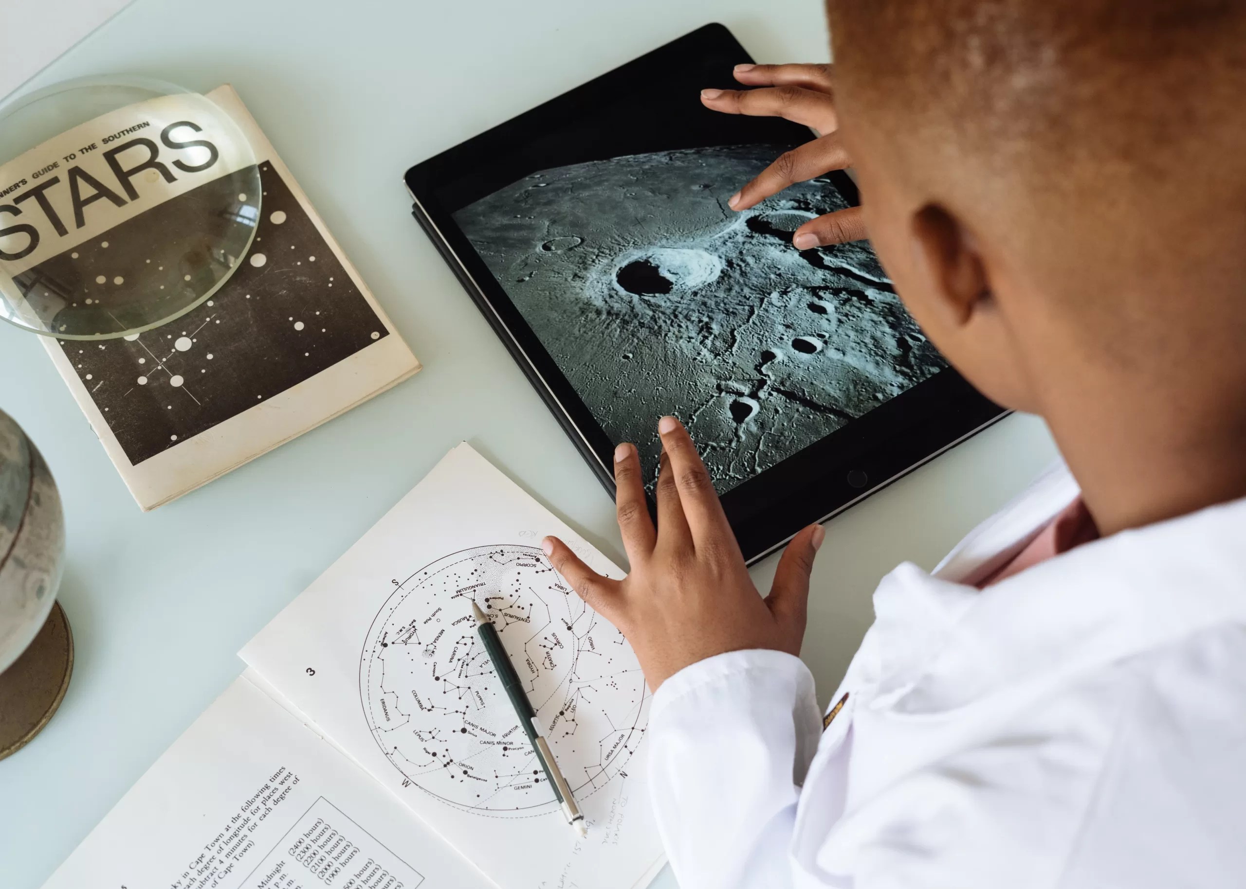 Screen time can be beneficial as seen here. A young boy is learning about space through a tablet.