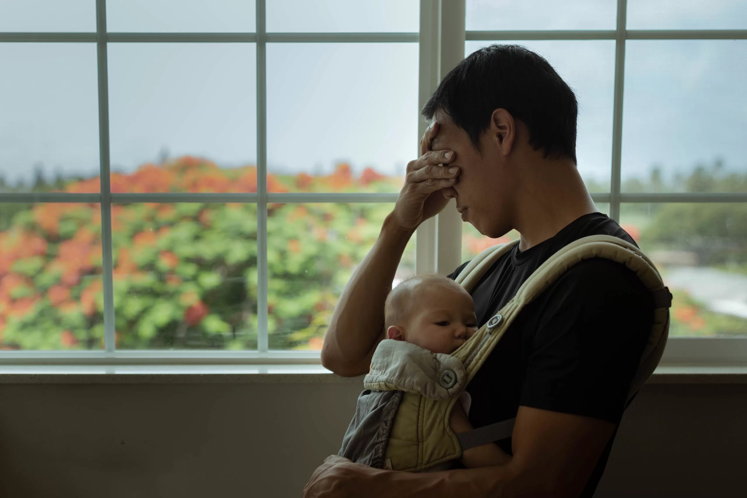 Young father suffering from Paternal Postpartum Depression