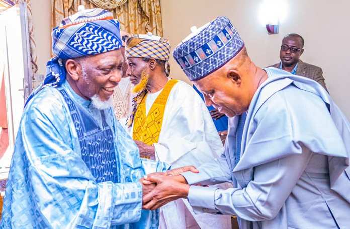 Sheikh Sani Yahaya Jingir in handshake with APC vice presidential candidate, Kashim Shettima