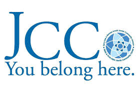 Daisy Khan speaking at a podium during a public event, addressing an audience on diversity, inclusion, interfaith collaboration, and combating Islamophobia.