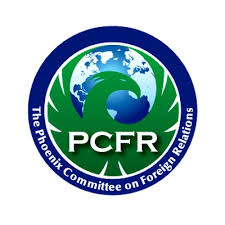 Daisy Khan delivering a speech from a podium, engaging an audience on topics of inclusion, interfaith unity, and addressing Islamophobia.