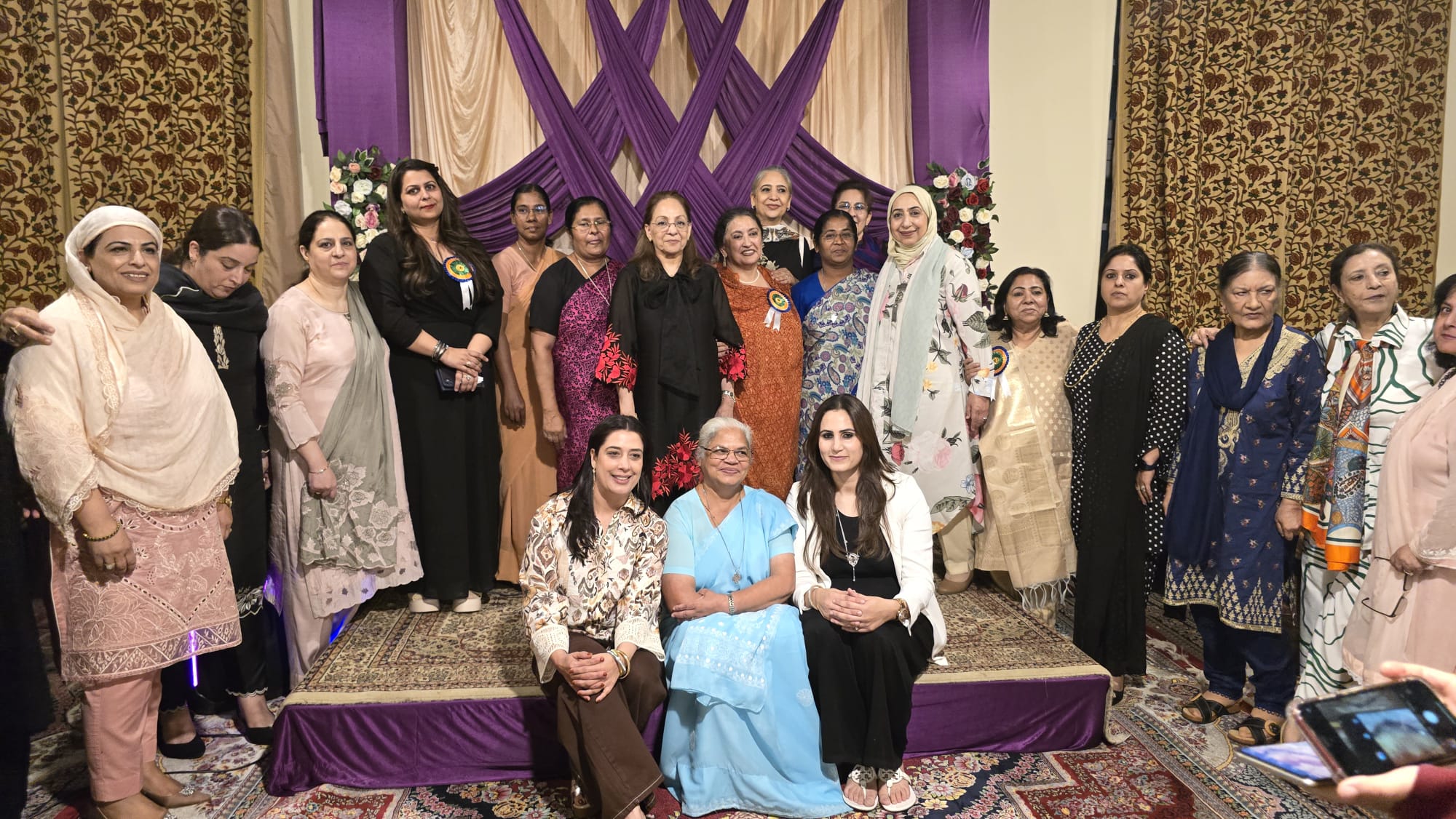 Daisy Khan engaging with diverse community members at a civic event promoting social justice and inclusion.