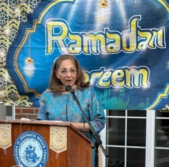 Daisy Khan speaking at a community event, fostering dialogue and collaboration among diverse civic groups.