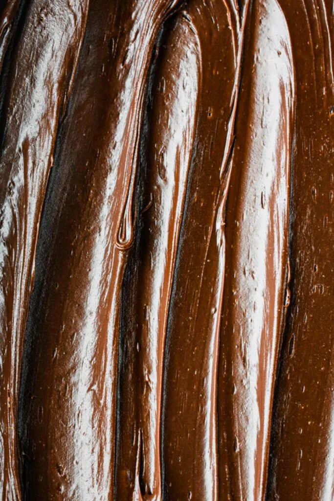 A smooth chocolate frosting spread on a cake.